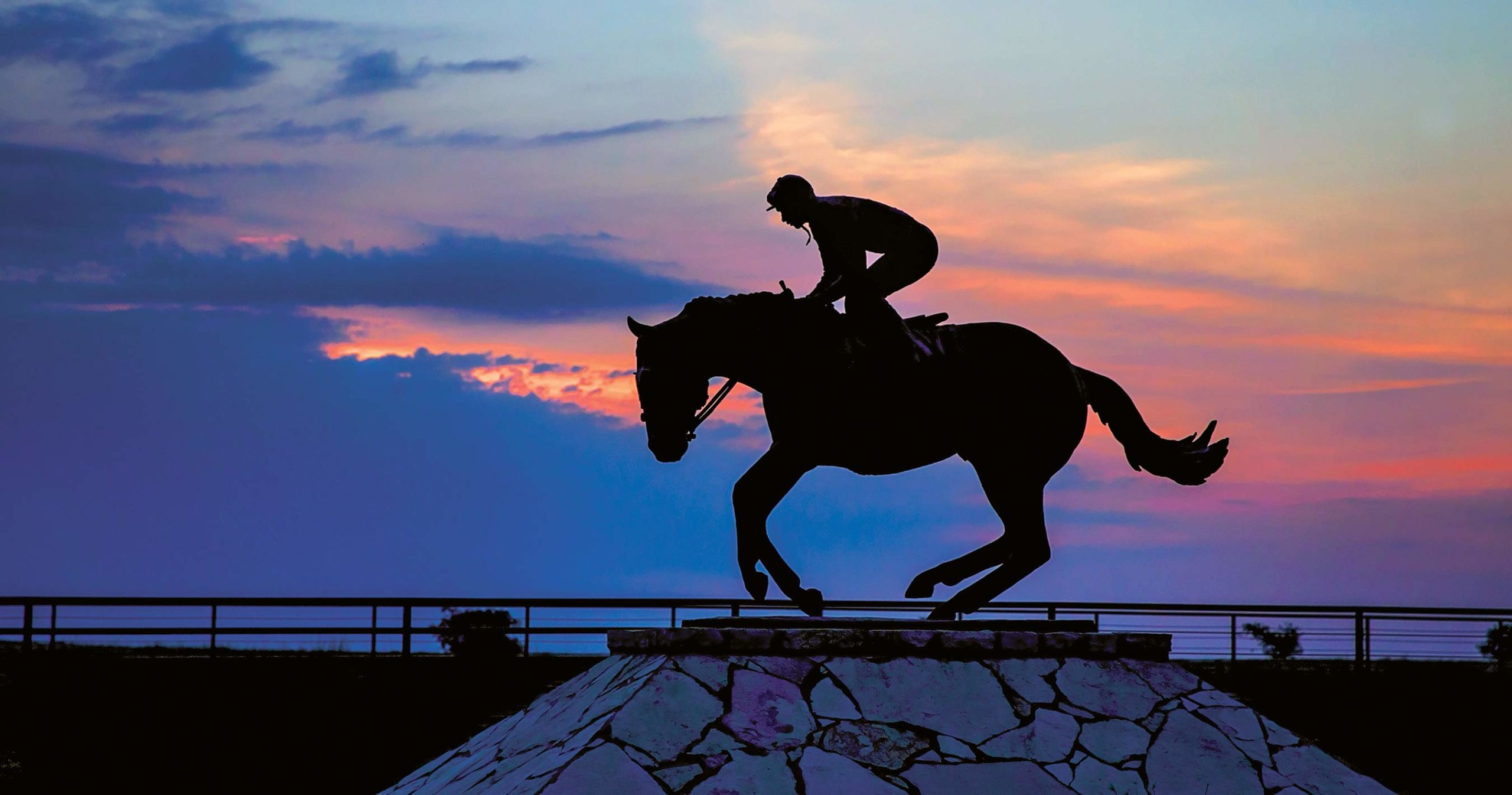 home-staging_01 Four Sixes Ranch heritage sculpture depicting a horse and rider silhouetted at sunset, symbolizing the legacy, pedigree, horsemanship, and ranching traditions that define the historic 6666 Ranch in Texas.